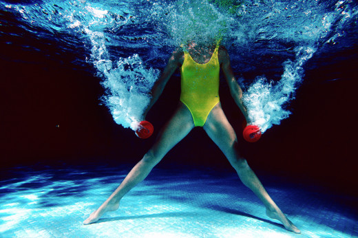 Aquatraining für SPORTS International 1988, Titelbild der Story über Margot Zeitvogel-Schönthier Aquatraining für SPORTS International 1988, Titelbild der Story über Margot Zeitvogel-Schönthier, rote Hanteln mit gestreckten Armen seitlich hoch und tief bewegen, Beine in Grätschstellung